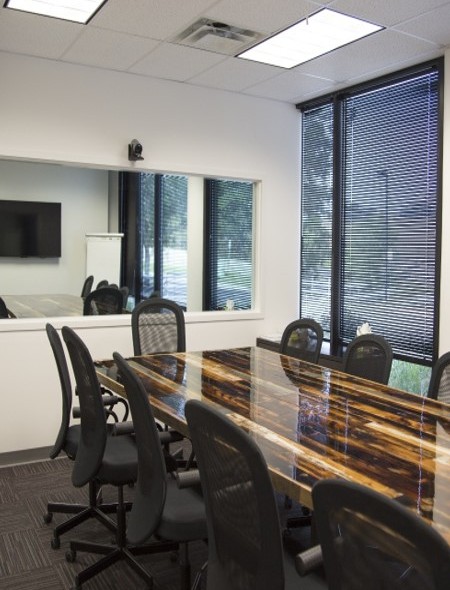 Focus group room with an observation window and TV monitor